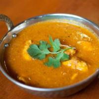 Chicken Curry · Cubes of boneless chicken cooked in a tomato based curry.