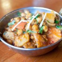 Chana Aloo · Garbanzo beans with potatoes, cooked in Indian spices.