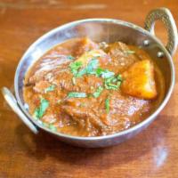 Lamb Vindaloo · Boneless lamb with potatoes, cooked in a hot and spicy curry.