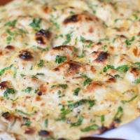 Garlic Naan · Tandoori naan topped off with seasonal garlic.