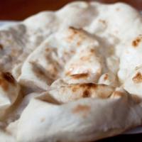 Naan · Traditional white flour bread baked in our clay oven.
