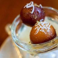 Gulab Jamun · Juicy milk balls dipped in honey syrup with a touch of rose water.