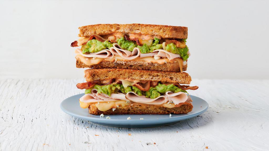 The Thursday · Roasted turkey, bacon, muenster cheese, blue cheese crumbles, avocado spread & Society Sauce on choice of bread