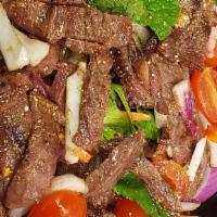 Beef Salad · Grilled beef with Thai herbs in spicy lime dressing.