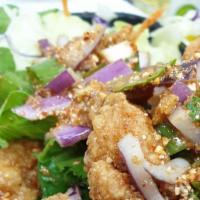 Crispy Chicken Larb Salad · Battered tender chicken and Thai herbs, roast rice powder with spicy lime sauce.