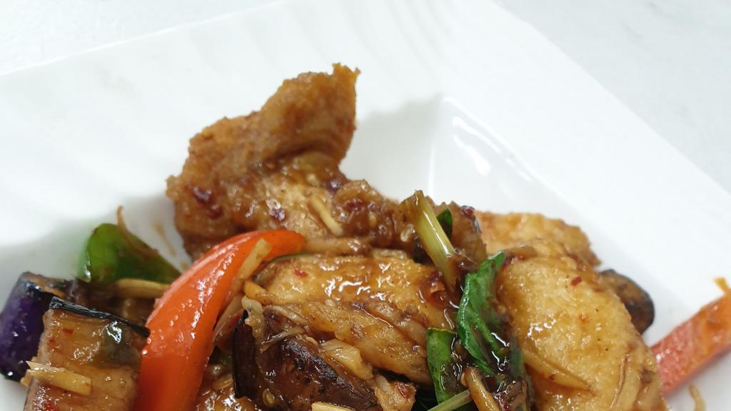 Spicy Catfish · Deep-fried catfish fillet and sautéed in chili paste with eggplant, bell pepper, wild ginger, and basil.