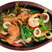 Pad Cha Seafood · A combination of shrimp, calamari, and salmon, sautéed with homemade curry paste, basil, wil...