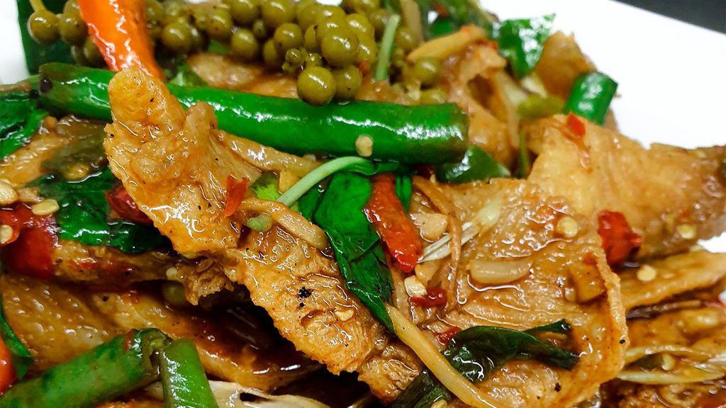 Pad Cha Catfish · Deep-fried catfish fillet, Sautéed in spicy homemade curry paste with basil, wild ginger, green bean, bell pepper, pepper-corn, and kaffir lime leaves.