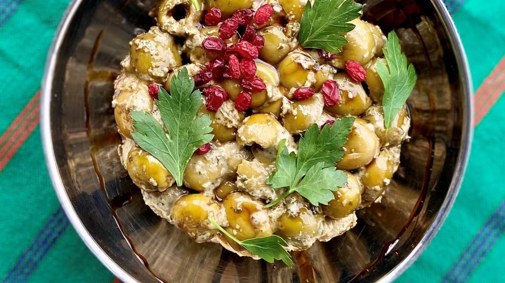 Marinated Olives / Zeitoun Parvardeh · Green olives, walnuts, pomegranate molasses, herb paste, Persian hogweed, olive oil, salt, and black pepper. 8oz.

Gluten free, vegan.