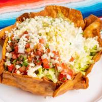 21.  Taco Salad · Crispy flour tortilla bowl filled with lettuce, beans, rice, cheese, pico de gallo, guacamol...