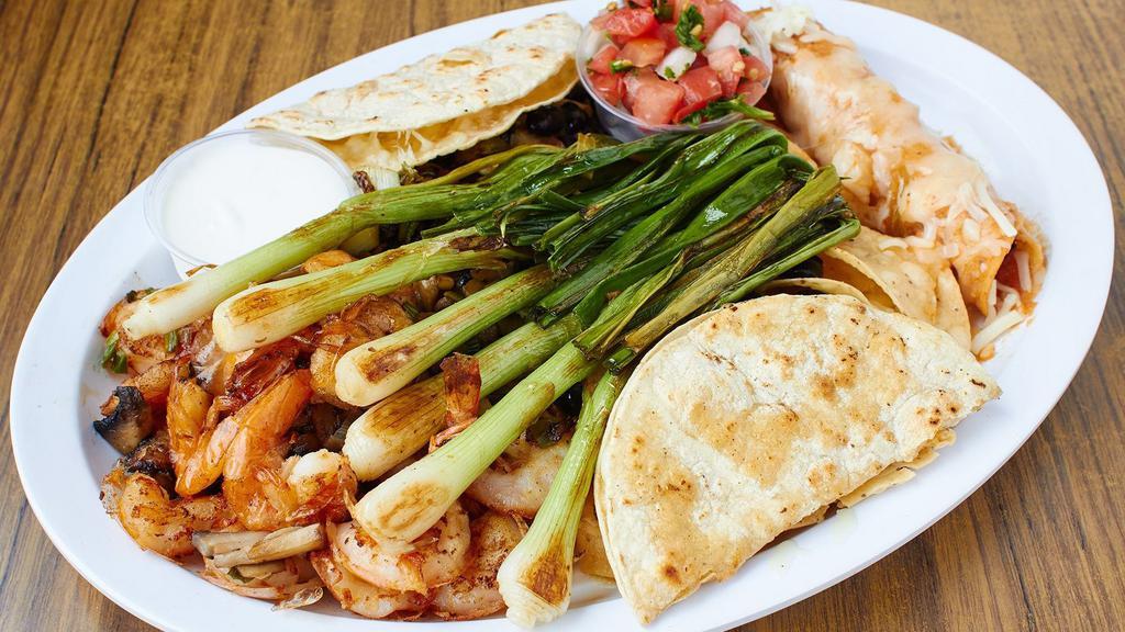 Fiesta Platter · Nachos, garlic prawns, chicken flauta, corn quesadilla, grilled onions, guacamole, sour cream, and salsa. Serves 2-4 persons.