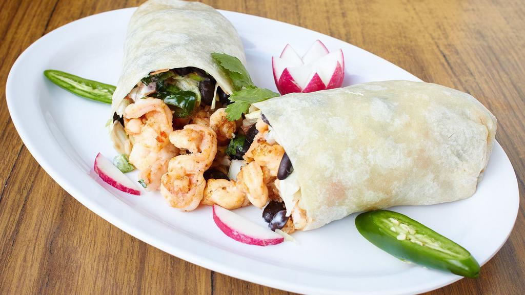 Steak & Prawns Seafood Burrito · With rice, beans and salsa. Make it super by adding cheese, guacamole, sour cream, lettuce and tomato; or make it mojado by smothering it in a savory sauce and topping it with cheese.