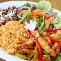 Chile Verde Pork Dinner · Pork in green sauce with rice, beans, salad and tortillas.