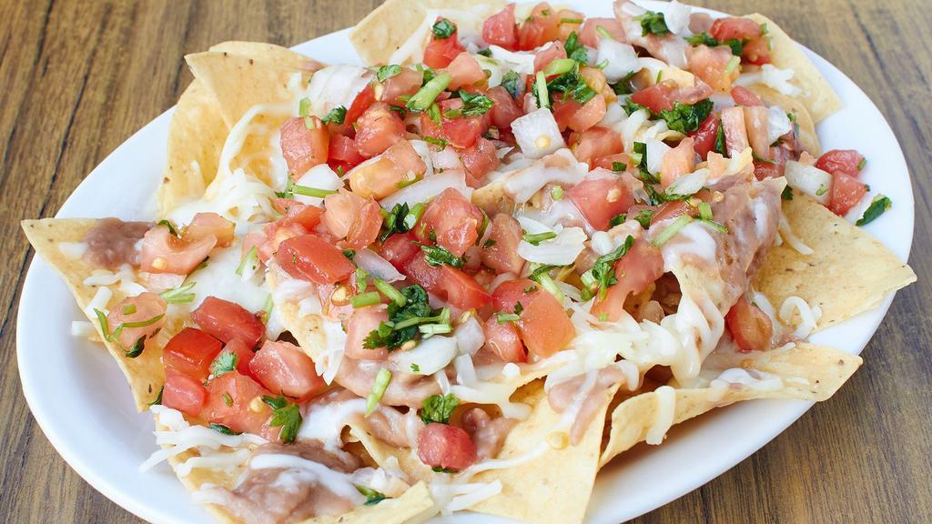 Prawns Nachos · House Made Corn Chips,, beans, cheese, garlic prawns and salsa. Make it super by adding cheese, guacamole, sour cream, lettuce and tomato.