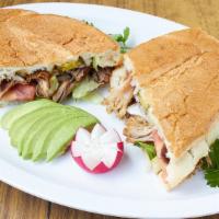 Torta Ahogada Sandwich · Smothered in a special Jalisco hot sauced and onions.