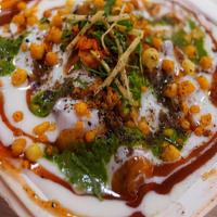 Dahi Papdi Chaat · Crunchy flat papdi with boiled potatoes with yogurt and chutneys.