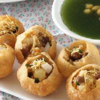 Pani Poori · Crispy Baked wafers serve with spicy mint water, Potatoes and Chana.