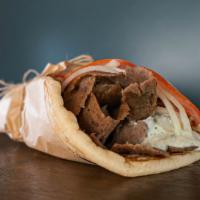 Gyro Pita · A seasoned beef cone cooked on a vertical rotisserie served on a warm pita bread, tomatoes, ...