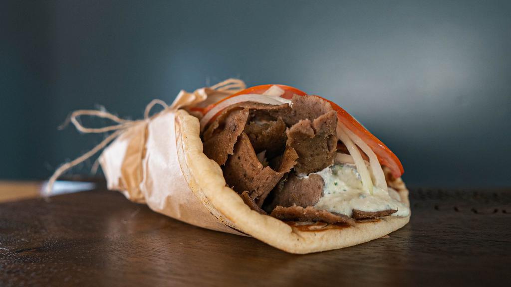 Gyro Pita · A seasoned beef cone cooked on a vertical rotisserie served on a warm pita bread, tomatoes, onions and tzatziki sauce.