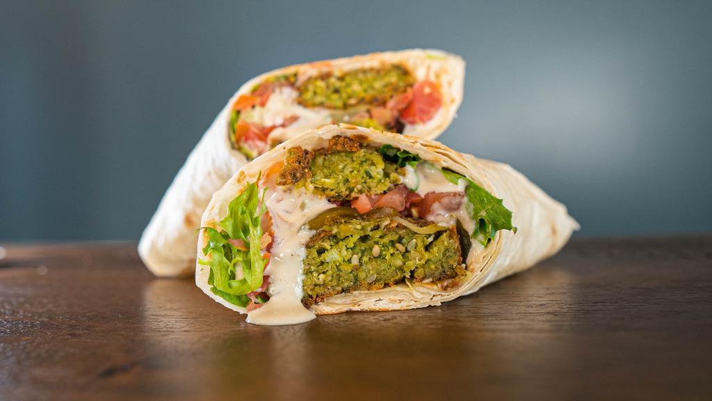 Falafel Wrap · Daily made falafel mix served on lavash with hummus, spring mix, tomatoes, pickles and tahini sauce.