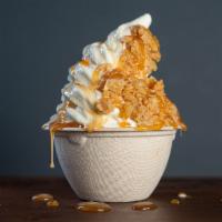 Baklava Ice Cream · Soft serve ice cream topped with crushed walnut baklava and caramel drizzle.