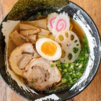 Shio Ramen · Our sea salt-based clear chicken soup topped with braised pork belly, soft-boiled egg, lotus...