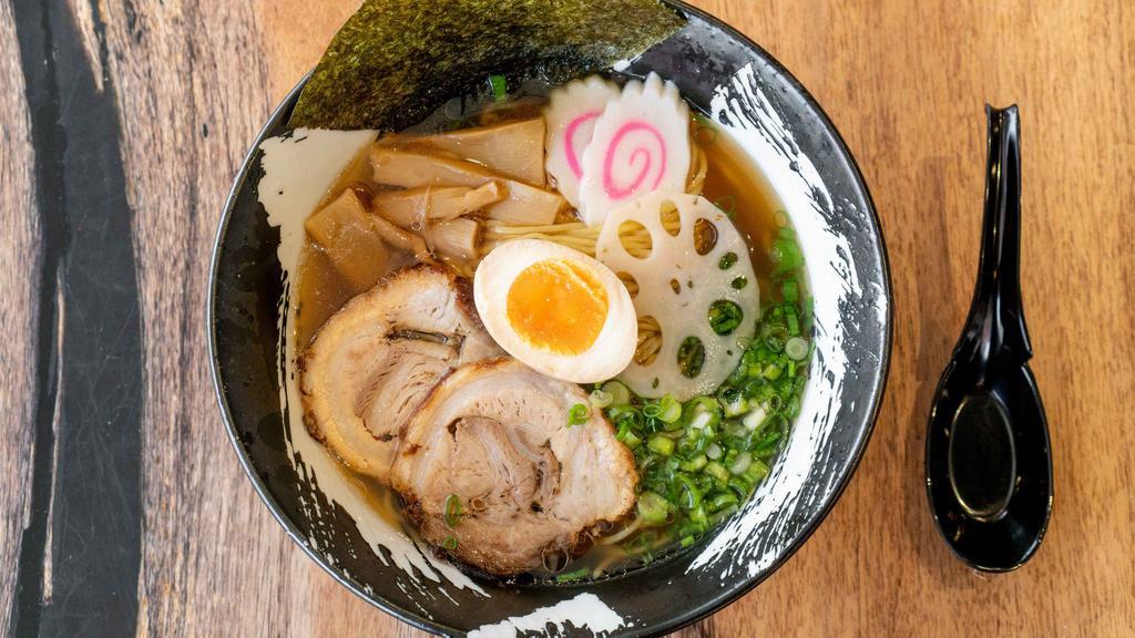 Shio Ramen · Our sea salt-based clear chicken soup topped with braised pork belly, soft-boiled egg, lotus root, fish cake, seasoned bamboo shoot, Tokyo leek and dried seaweed.