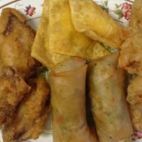 13. Assorted Appetizers · Combination of two egg rolls, four fried wings. Five fried prawns and scrab-cheese puffs.