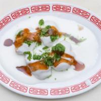 Dahi Bhalla Chaat · Deep-fried lentil fritters topped with yogurt, spicy green chutney, and tamarind chutney.