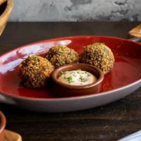 Croquetas de Cangrejo · Dungeness crab and squid ink croquette served with black ink aioli.
