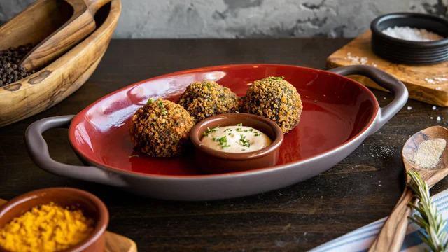 Croquetas de Cangrejo · Dungeness crab and squid ink croquette served with black ink aioli.