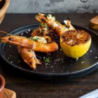 Gambas a La Plancha · Grilled peel-and-eat gulf prawns with garlic olive, and charred lemon.