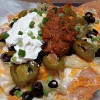 The Twist Nachos · Mixed Cheese, Salsa, Sour Cream, Black Olives, Pickled Jalapenos, Pepperoncini & Green Onions