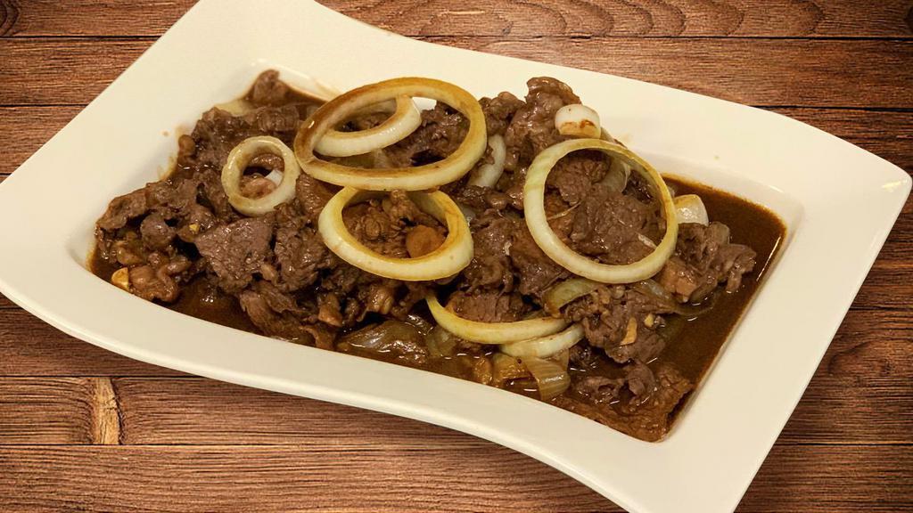 Beef Bistek (32oz) · Thinly cut tender beef slices cooked in soy sauce and calamansi (Filipino lime) with generous amount of onion rings