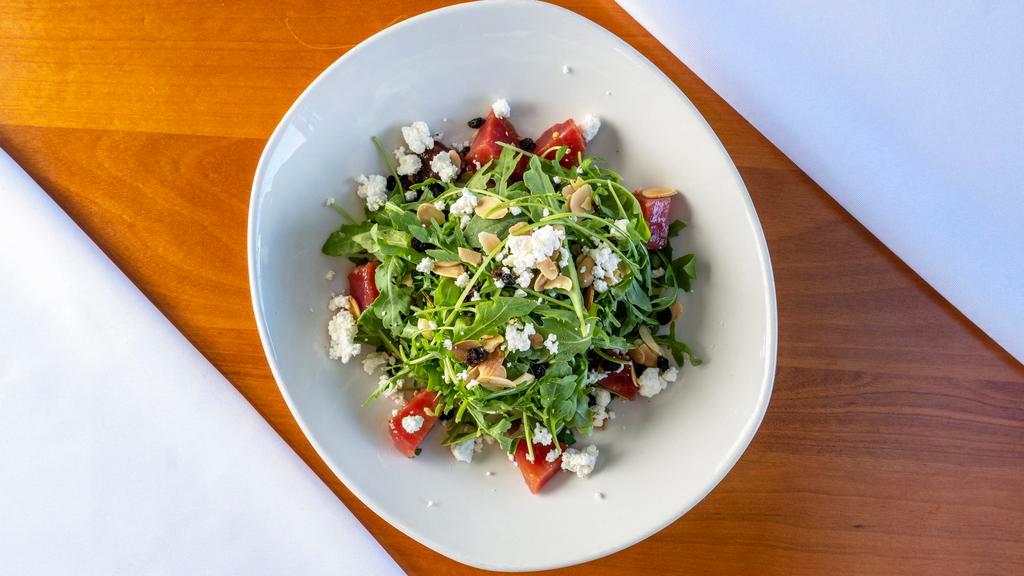 Beet Salad · Wild arugula, roasted beets, goat cheese, dried currants, toasted almonds, strawberry vinaigrette.