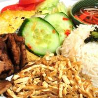 30. Sai Gon Rice Plate · Seasoned shredded tofu, soy protein, and tofu cake served over rice with a side salad.