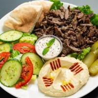 Beef Shawarma Plate · Shredded Beef topped with Tahini Sauce, Red Onions & Pickles, Hummus Green Salad & Pita