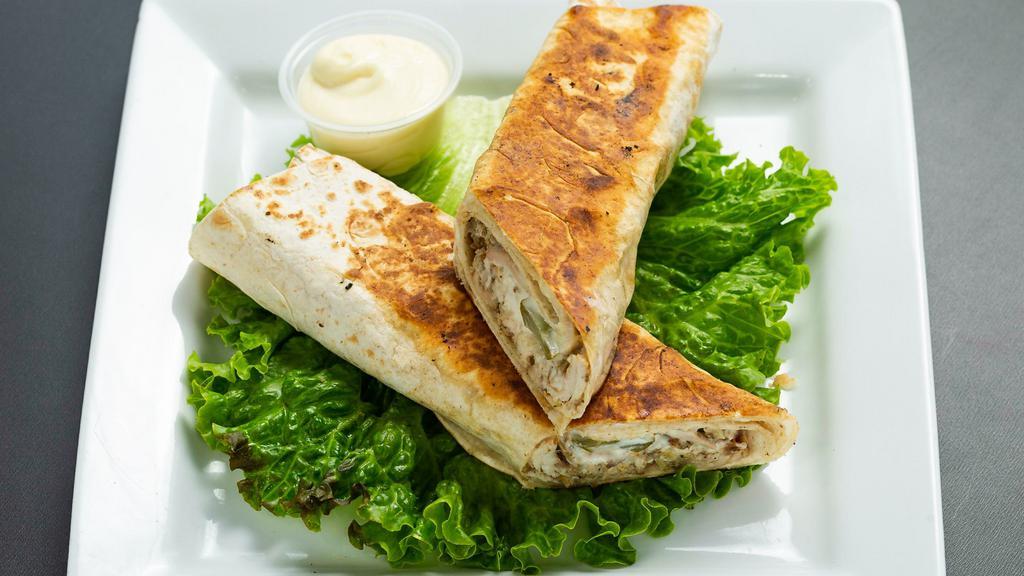 Chicken Shawarma Wrap · Shredded Chicken, Pickles, Red Onions & Garlic Sauce wrapped in Lavash. Pressed on the Grill.