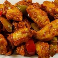 Manchurian Wings  (Bone-in) · Crispy chicken wings tossed in fresh garlic and our sweet and spicy manchurian sauce. (Sweet...