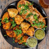 Street Sampler · 6  pieces of Tandoori Wings, 4 pieces Curry Bread & 
4 pieces of Samosa Bites. Served with s...