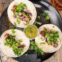 Lamb Kebab Tacos · Ground lamb marinated in kebab spices, red onions, mint sauce and fresh cilantro. (3 Tacos)