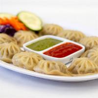 Chicken Mo Mo · Steamed minced chicken with cabbage, green onions, cilantro, chives and spices wrapped in wh...