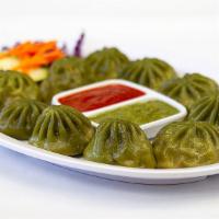 Veggie Mo Mo · Cauliflower, cabbage, carrots, green onions, cilantro, chives and spices wrapped in white fl...