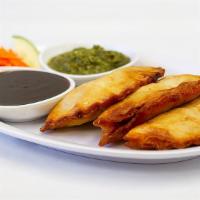 Chicken · Fried pocket with chicken, peas and spices.