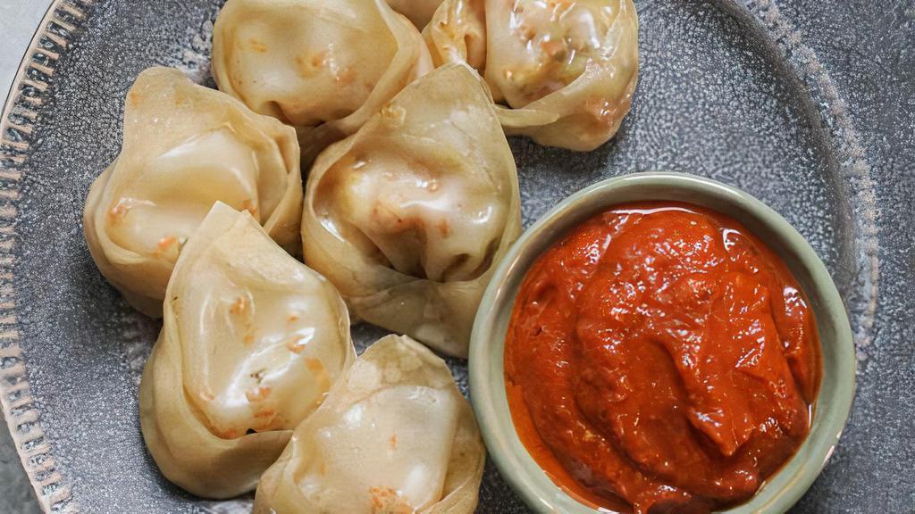 People's Paneer Momos · Minced paneer Nepali dumplings served with traditional dipping sauce. Choice of steamed, fried, or chilly