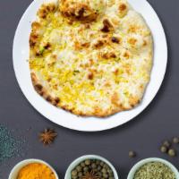 Garlic Naan  · Freshly baked bread in a clay oven garnished with garlic and butter. Talk about getting' fre...