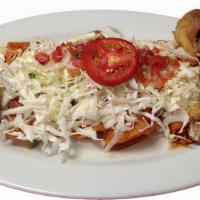 Enchiladas Michoacanas · Seven corn tortillas stuffed with Mexican cheese, topped with cabbage, pico de gallo, Mexica...