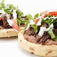 Sopes · Thick round fried tortilla. Choice of meat, beans, sour cream, salsa, lettuce, tomato Mexica...