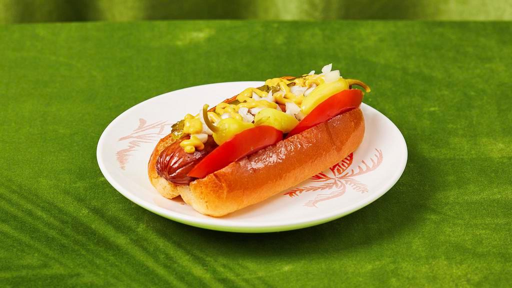 Chicago Style Hot Dog · Hot dog with yellow mustard, chopped white onions, sweet relish, a dill pickle spear, and tomato.