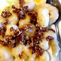 Walnut Prawns · Prawns crisp sauteed in a tangy white cream sauce topped with honey-glazed walnuts.